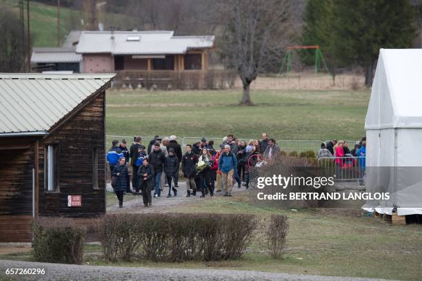 Relatives and friends of victims leave the commemoration ceremonies at the Vernet memorial, southeastern France, on March 24, 2017 to mark the second...