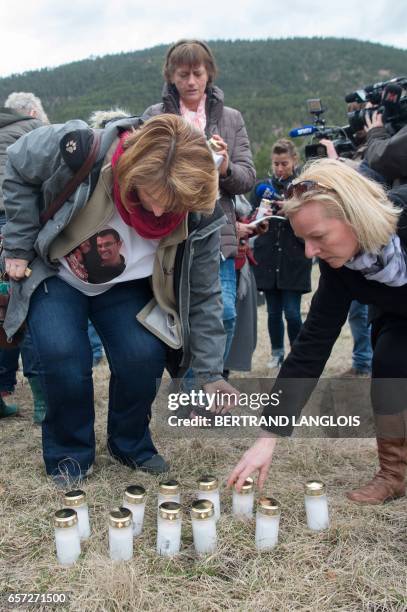 Relatives and friends of victims set candles during the commemoration ceremonies at the Vernet memorial, southeastern France, on March 24, 2017 to...