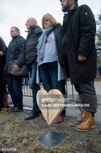 German relatives and friends of victims stand next to a sculpture following the commemoration ceremonies at the Vernet memorial, southeastern France,...