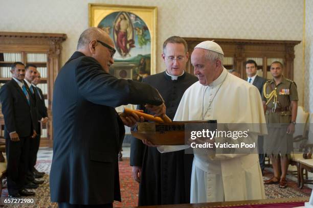 Pope Francis exchanges gifts with President of Fiji Jioji Konousi Konrotea during a private audience at the Apostolic Palace on March 24, 2017 in...