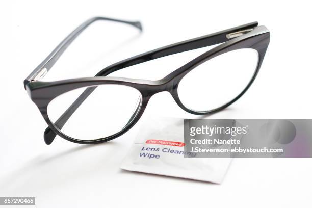closeup of eyeglasses and lens cleaner - nanette j stevenson ストックフォトと画像