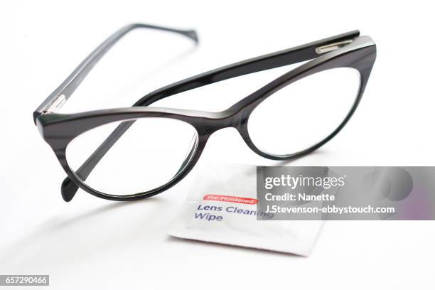 closeup of eyeglasses and lens cleaner - nanette j stevenson stock pictures, royalty-free photos & images