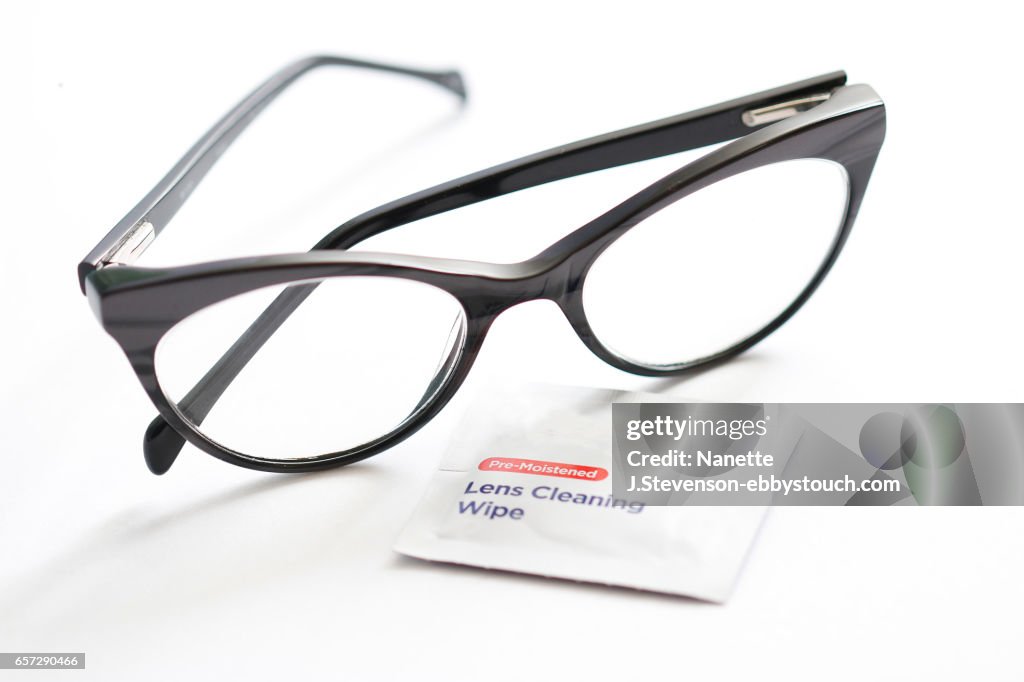 Closeup of eyeglasses and lens cleaner