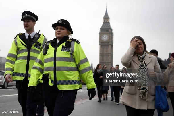 Police officers patrol on Westminster Bridge on March 24, 2017 in London, England. A fourth person has died after Khalid Masood drove a car into...