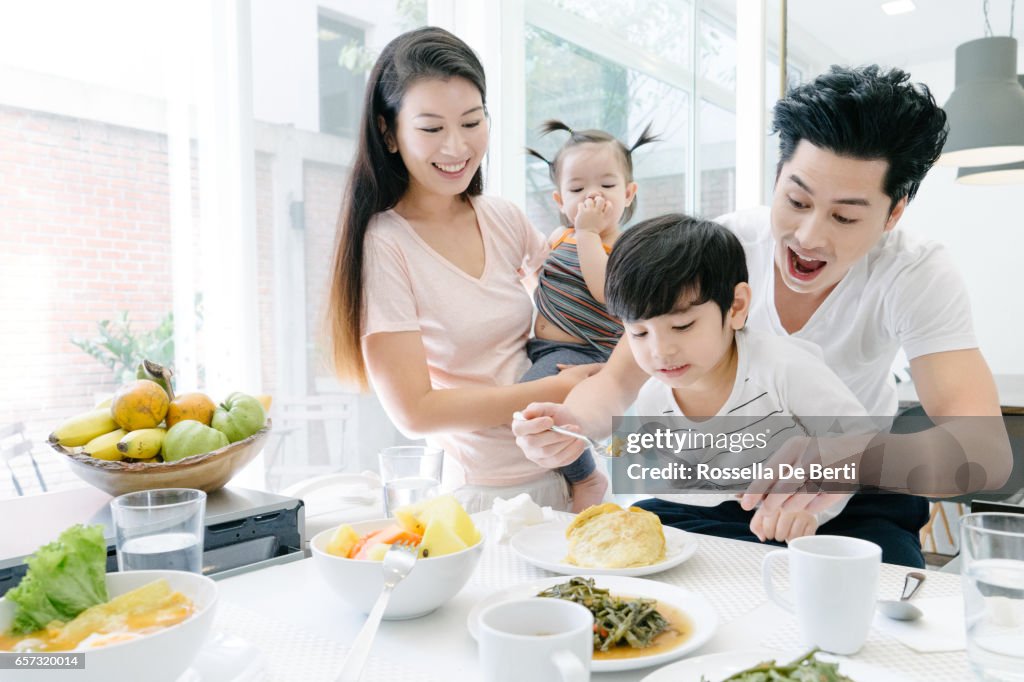 Young family having breakfast in the kitchen