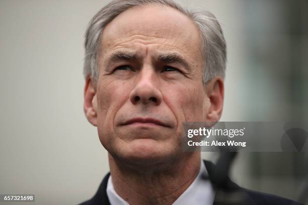 Texas Governor Greg Abbott participates in a news briefing outside the West Wing after an Oval Office announcement with President Trump March 24,...