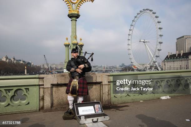 Man plays bagpipes on Westminster Bridge on March 24, 2017 in London, England. A fourth person has died after Khalid Masood drove a car into...