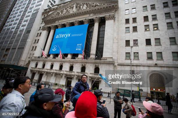 Alteryx Inc. Signage is displayed in front of the New York Stock Exchange during the company's initial public offering in New York, U.S., on Friday,...