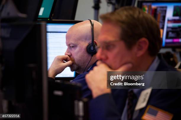 Traders work on the floor of the New York Stock Exchange in New York, U.S., on Friday, March 24, 2017. U.S. Stocks pared the worst weekly drop of the...