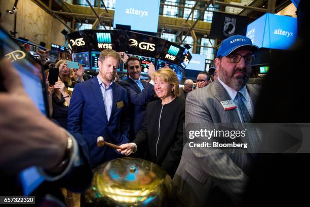 Olivia Duane-Adams, chief customer officer of Alteryx Inc., center right, rings a ceremonial bell with Ned Harding, chief technology officer of...