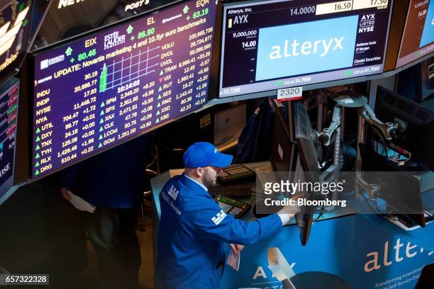 Trader works on the floor of the New York Stock Exchange during the Alteryx Inc. Initial public offering in New York, U.S., on Friday, March 24,...