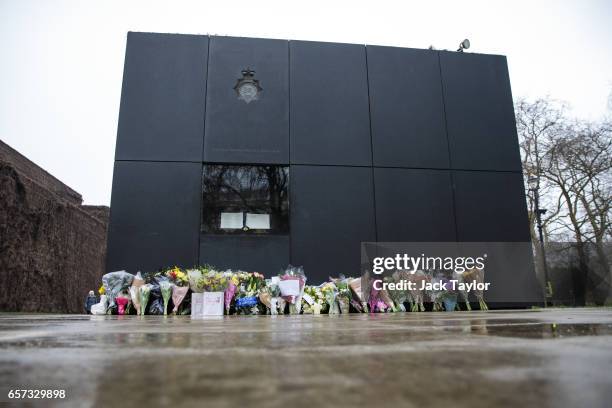 Floral tributes lay in front of the National Police Memorial on March 24, 2017 in London, England. A fourth person has died after Khalid Masood drove...