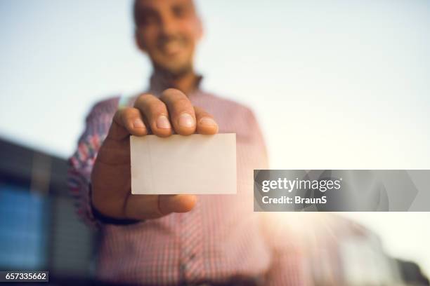 close up of a empty business card in man's hand. - business card stock pictures, royalty-free photos & images