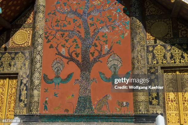 Tree of Life mosaic on the sims back wall of Wat Xieng Thong in the UNESCO world heritage town of Luang Prabang in Central Laos.