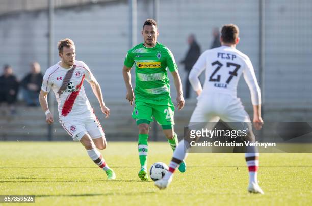 Timothee Kolodziejczak of Borussia Moenchengladbach is chased by Christopher Buchtmann of FC St. Pauli during the Friendly Match between Borussia...