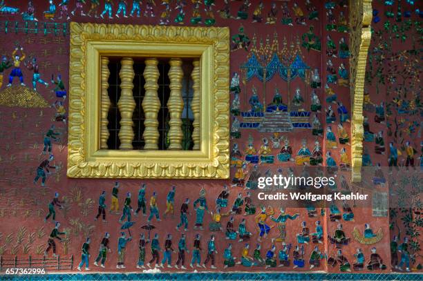 Some of the exterior walls of the buildings at the Wat Xieng Thong in the UNESCO world heritage town of Luang Prabang in Central Laos contain...