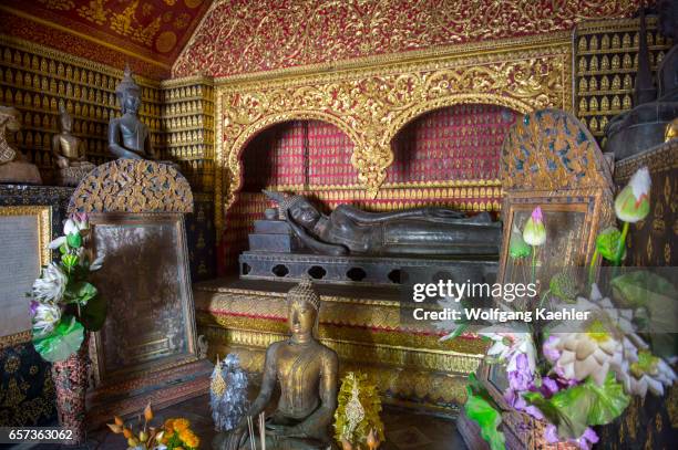 Buddha statues in one of the buildings at the Wat Xieng Thong in the UNESCO world heritage town of Luang Prabang in Central Laos.
