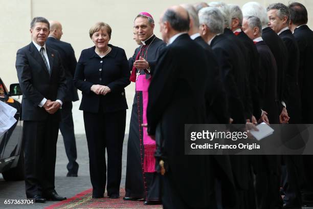 Germany's Chancellor Angela Merkel is welcomed by the prefect of the papal household Georg Gaenswein as she arrives at the Apostolic Palace for an...