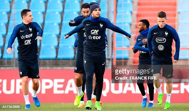 France's forward Florian Thauvin, defender Adil Rami, defender Layvin Kurzawa and forward Kevin Gameiro run during a training session at the Josy...
