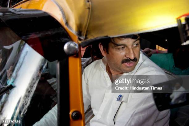 Delhi state President Manoj Tiwari driving an auto rickshaw after many auto drivers joined the party on March 24, 2017 in New Delhi, India....