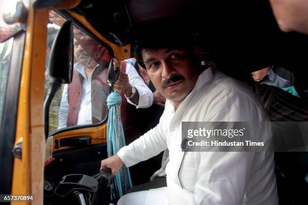 Delhi state President Manoj Tiwari driving an auto rickshaw after many auto drivers joined the party on March 24, 2017 in New Delhi, India....