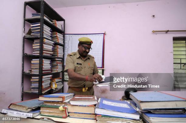 Police personnel clean the office at police station on March 24, 2017 in Noida, India. New UP Chief Minister Yogi Adityanath has ordered that the...