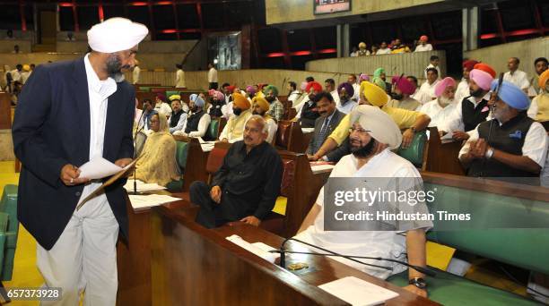 Punjab Cabinet Minister Manpreet Badal interacting with CM Capt. Amrinder Singh on the first day of Punjab Vidhan Sabha session on March 24, 2017 in...