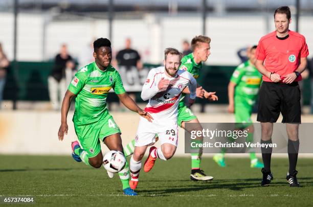 Ba-Muaka Simakala of Borussia Moenchengladbach is chased by Jan-Marc Schneider of FC St. Pauli during the Friendly Match between Borussia...