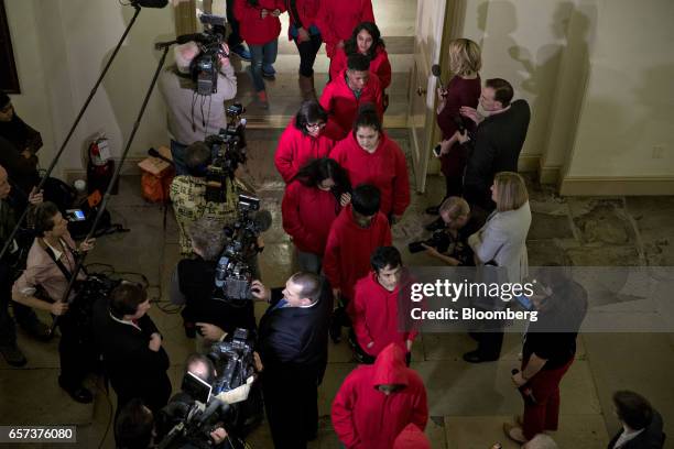 Tour group walks past members of the media at the U.S. Capitol while waiting for U.S. House Speaker Paul Ryan, a Republican from Wisconsin, not...