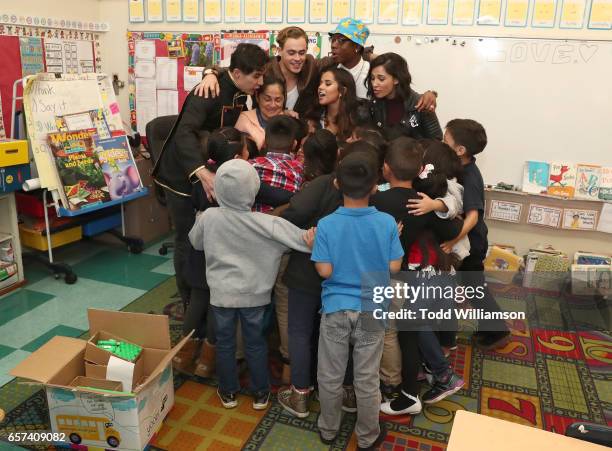 Ludi Lin, Dacre Montgomery, Becky G, RJ Cyler and Naomi Scott group hug with students and their teacher at a Saban's Power Rangers - "Give Day" Event...