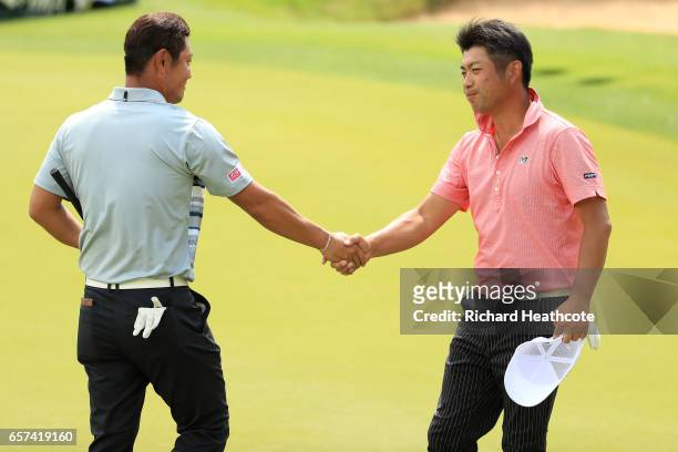 Hideto Tanihara of Japan shakes hands with Yuta Ikeda of Japan after winning their match 3&1 during round three of the World Golf Championships-Dell...
