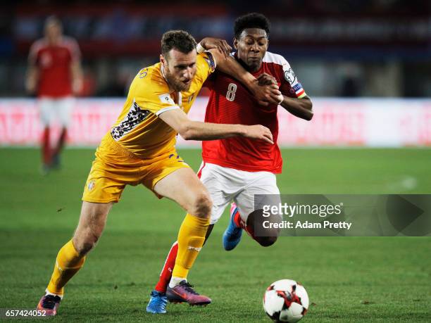 David Alaba of Austria is challenged by Victor Golovatenco of Moldova during the Austria v Moldavia 2018 FIFA World Cup Qualifier match at Ernst...