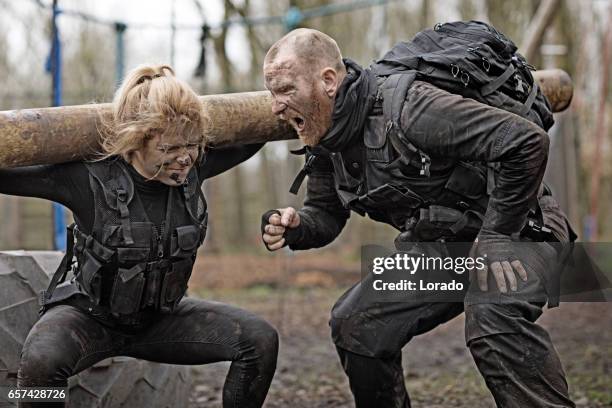 male and female soldiers in military shoot in woodlands - treino militar imagens e fotografias de stock
