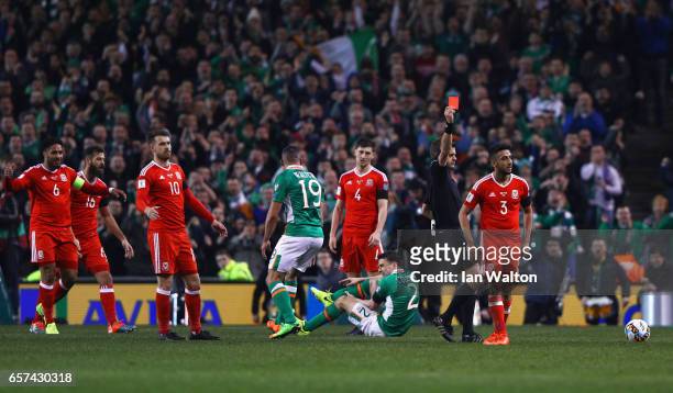 Players react as Neil Taylor of Wales is shown a red card by referee Nicola Rizzoli and is sent off after a challenge on Seamus Coleman of the...