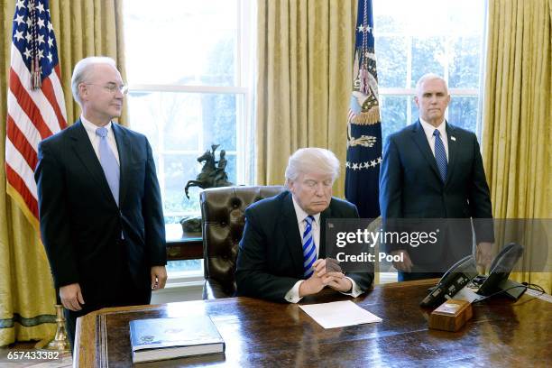 President Donald Trump reacts with HHS Secretary Tom Price and Vice President Mike Pence after Republicans abruptly pulled their health care bill...