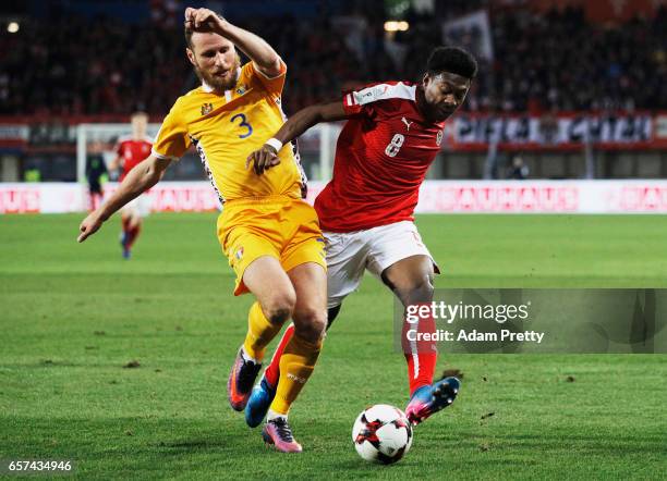 David Alaba of Austria is challenged by Victor Golovatenco of Moldova during the Austria v Moldavia 2018 FIFA World Cup Qualifier match at Ernst...