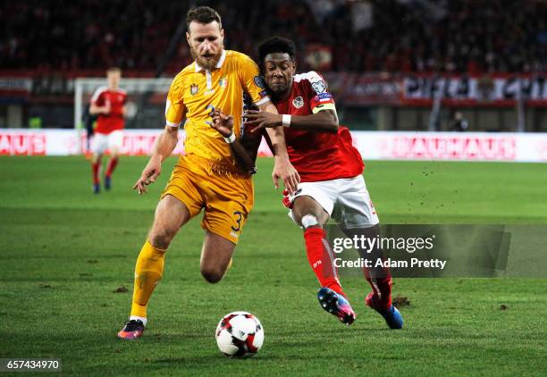 David Alaba of Austria is challenged by Victor Golovatenco of Moldova during the Austria v Moldavia 2018 FIFA World Cup Qualifier match at Ernst...