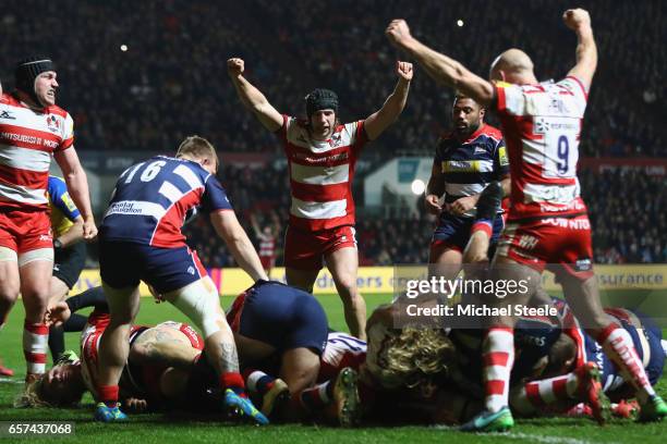 Billy Twelvetrees nd Willi Heinz of Gloucester lead the celebrations as Lewis Ludlow scores a try during the Aviva Premiership match between Bristol...