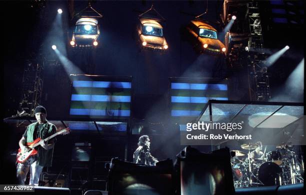 Perform on stage at Feyenoord Stadiium on the Zoo TV-Zooropa Tour, De Kuip, Rotterdam, Netherlands, 9th May 1993. L-R The Edge, Bono, Larry Mullen Jr.