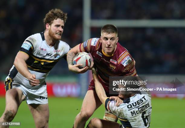 Huddersfield Giants' Alex Mellor is tackled by Leeds Rhinos' Danny Maguire and Anthony Mullally during the Betfred Super League match at the John...