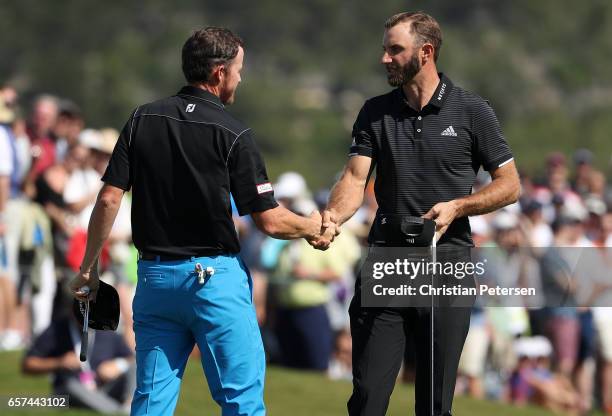 Dustin Johnson shakes hands with Jimmy Walker after winning their match 5&3 on the 15th hole during round three of the World Golf Championships-Dell...