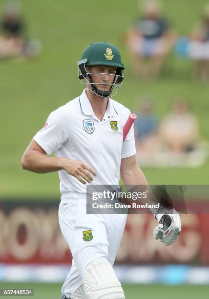 Theunis de Bruyn of South Africa leaves the field after being caught by Tom Latham of New Zealand and bowled by Matt Henry of New Zealand during day...