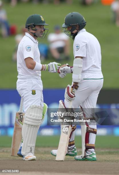 Jean-Paul Duminy and Hashim Amla of South Africa during day one of the Test match between New Zealand and South Africa at Seddon Park on March 25,...