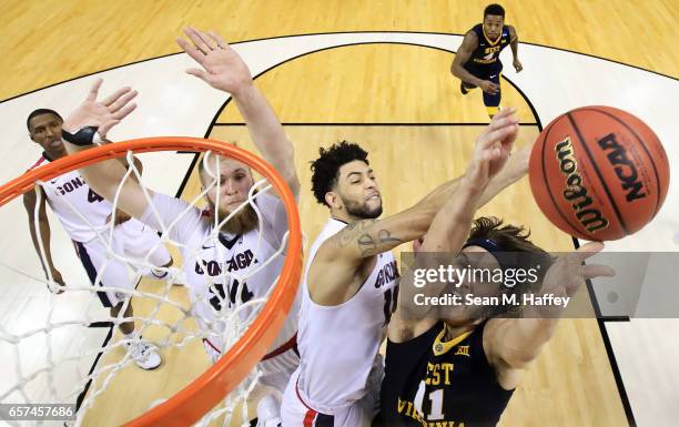 Nathan Adrian of the West Virginia Mountaineers goes up against Josh Perkins of the Gonzaga Bulldogs during the 2017 NCAA Men's Basketball Tournament...