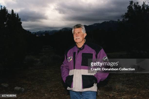 Actor George Lazenby who played James Bond in film poses for a portrait session wearing motorcycle gear in circa 1995 in Los Angeles, California.