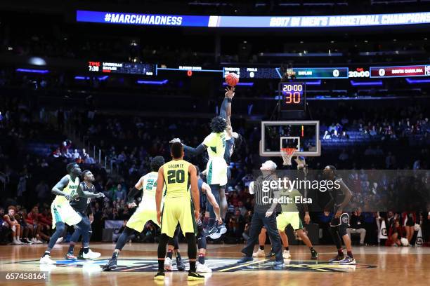 Johnathan Motley of the Baylor Bears tips off against Chris Silva of the South Carolina Gamecocks to start the first half during the 2017 NCAA Men's...