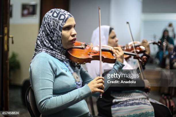 Partially-sighted women use musical instruments as they receive music education in Cairo, Egypt on March 24, 2017.