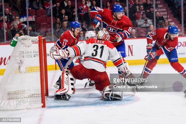 Montreal Canadiens right wing Brendan Gallagher , Brandon Davidson and Alex Galchenyuk waiting for the puck in from of Carolina Hurricanes goalie...