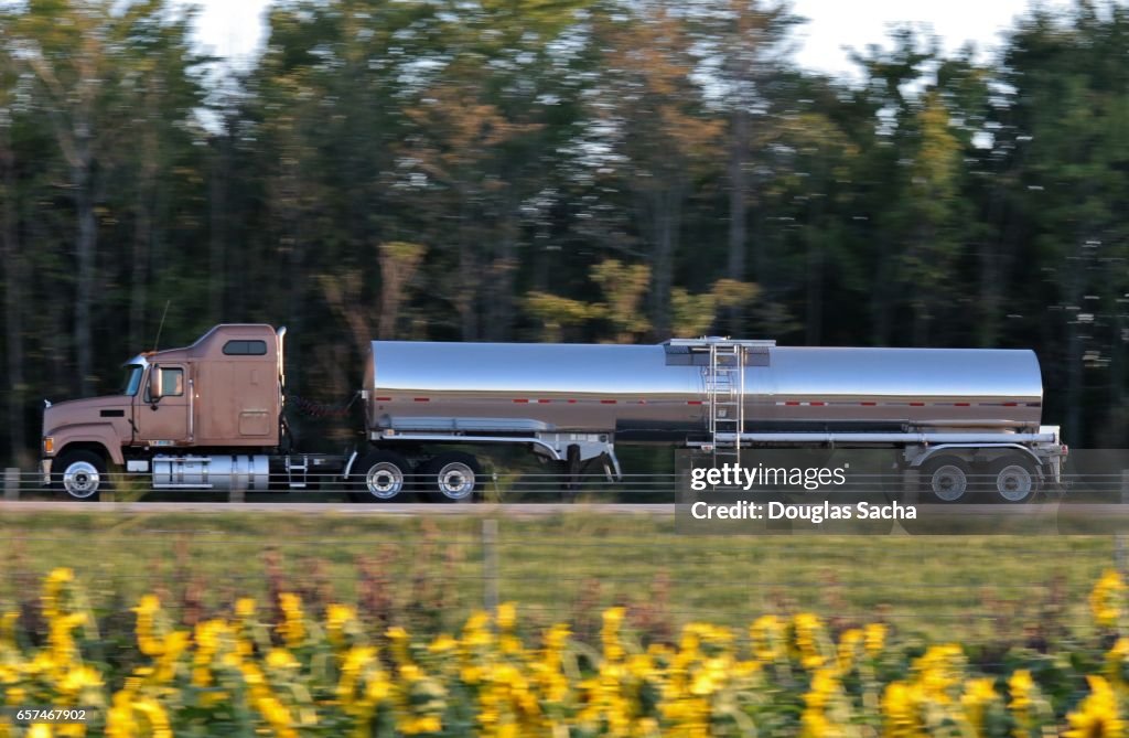 Long range semi tractor and trailer with Liquid container on the highway