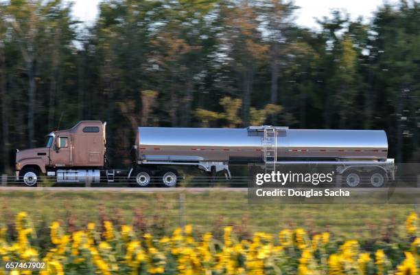 long range semi tractor and trailer with liquid container on the highway - fuel truck stock pictures, royalty-free photos & images